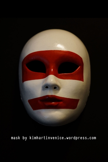 red and white mask with text